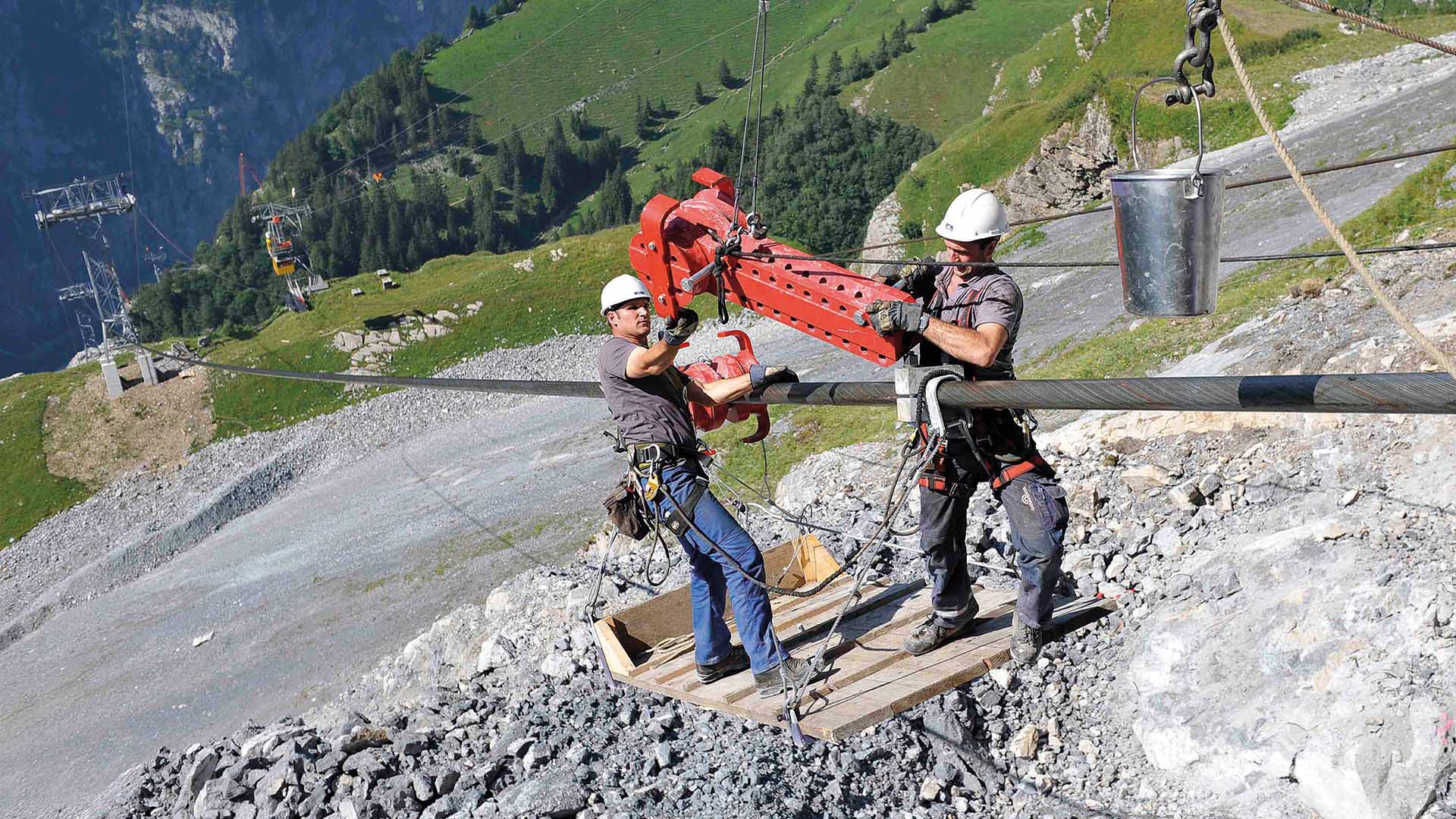 Deux spécialistes travaillent sur un câble.